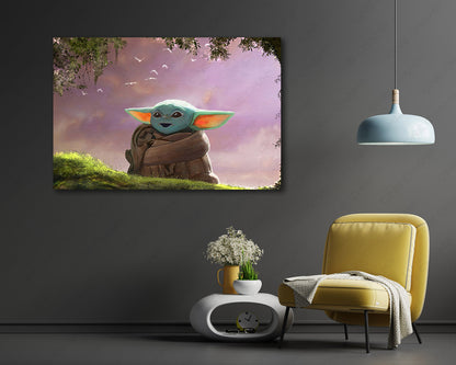 A framed wall art print showing a teal baby-like character in a brown robe against a pink-purple sky, displayed above a yellow chair and small white side table in a modern room.